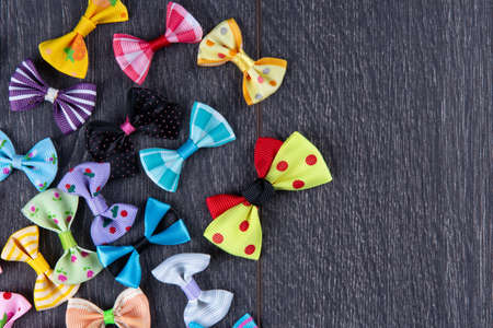 multi-colored decorative fabric bows on a wooden table top view