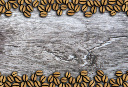 roasted coffee beans in a row on a wooden background illustrationの写真素材