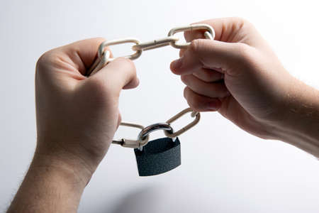 padlock with steel chain in the human hands top viewの写真素材