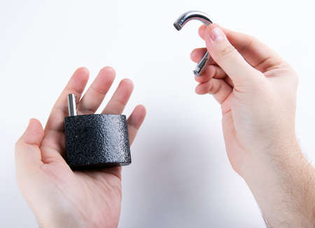 broken padlock in the human hands top viewの写真素材