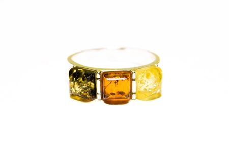Silver ring with three kinds of amber isolated on white backgroundの写真素材