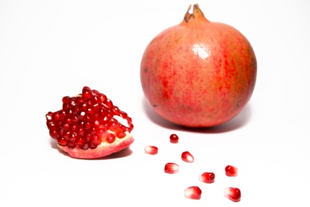 Red pomegranate and seeds isolated on white background. Selective focusの写真素材