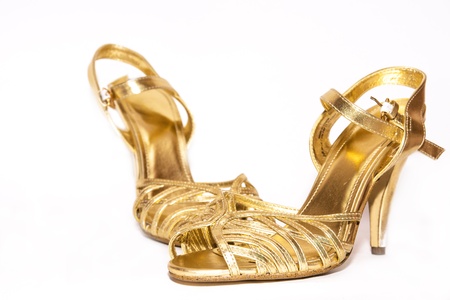 Woman golden shoes isolated on white, selective focusの写真素材