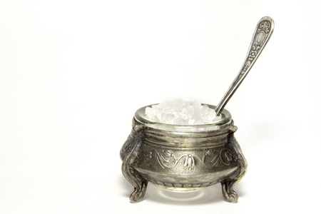 Very old silver plated salt  shaker with spoon isolated on white background.の写真素材