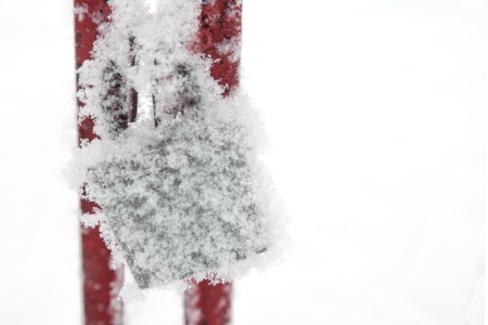 Snow covered retro padlock. Symbol of indifference, despair and depression.の写真素材
