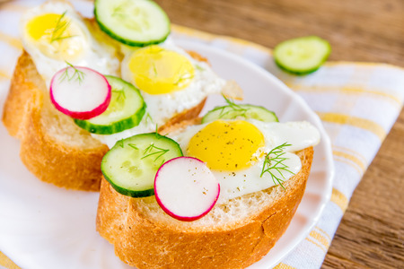 Buns with eggs and vegetables - healthy breakfastの写真素材