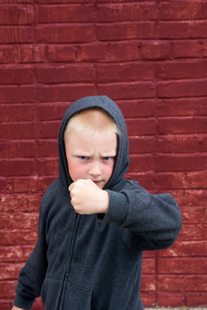 Children fight near brick wallの写真素材