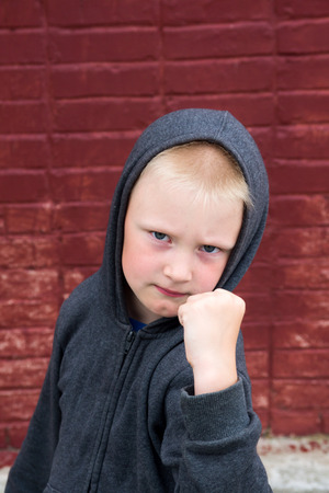 Children fight near brick wallの写真素材