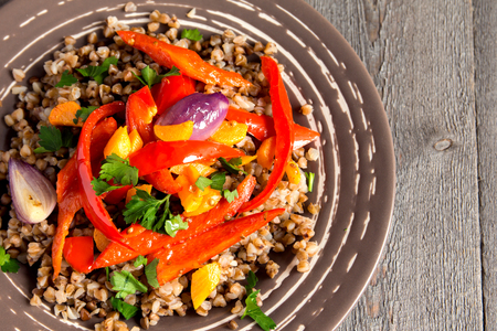 Buckwheat with vegetables and spices on plateの写真素材