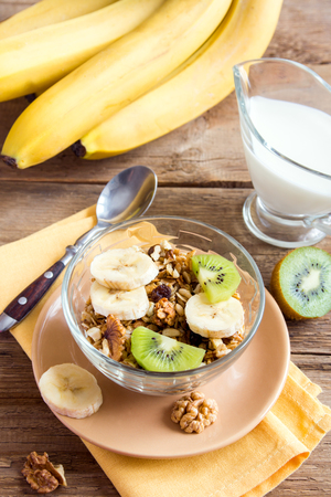 Homemade granola with fruits (banana, kiwi) and nuts for healthy breakfastの写真素材
