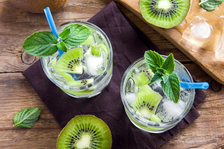 Kiwi drink (cocktail) with mint and ice in glasses close upの写真素材