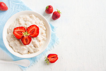 Oatmeal porridge with strawberries in bowl for healthy breakfastの写真素材