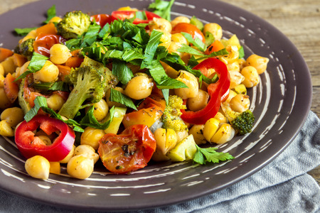 Homemade spicy vegetarian stew with chickpeas and vegetables on plate close up - healthy vegetarian foodの写真素材
