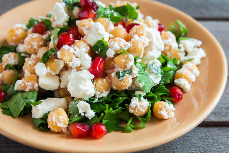 Chickpea salad with fresh feta cheese, parsley and pomegranate seeds - healthy organic homemade vegan vegetarian diet detox food meal saladの写真素材