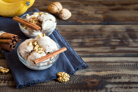 Healthy raw vegan banana and cinnamon ice cream (icecream, nicecream) with walnut topping - healthy vegetarian diet vegan raw fruit organic delicious dessert, dairy free, gluten freeの写真素材