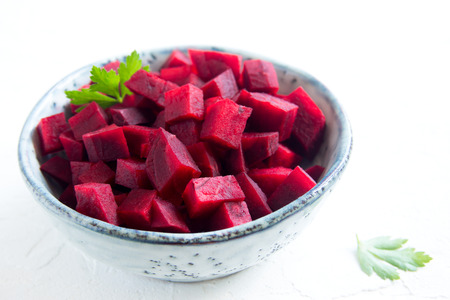 Beetroot (beet) chopped for salad in bowl over white background with copy space. Healthy ingredient for cooking.の写真素材