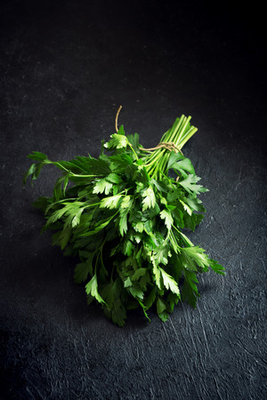 Organic Italian Parsley closeup on black background, healthy vegetarian food ingredient. Fresh Parsley.の写真素材