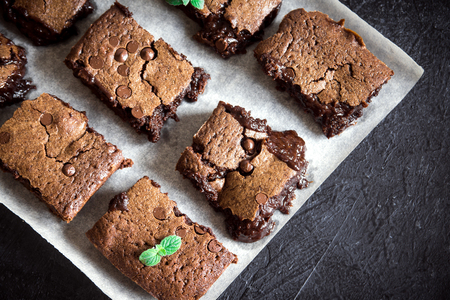 Brownies. Homemade chocolate fudge brownies on rustic black background, top view.の写真素材