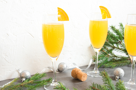 Mimosa festive drink for Christmas - Champagne cocktail Mimosa with Orange juice for Christmas party, copy spaceの写真素材