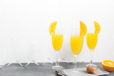 Mimosa drink for party - Champagne cocktail Mimosa with Orange juice over white background, copy spaceの写真素材