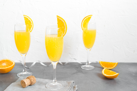 Mimosa drink for party - Champagne cocktail Mimosa with Orange juice over white background, copy spaceの写真素材