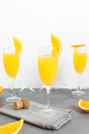Mimosa drink for party - Champagne cocktail Mimosa with Orange juice over white background, copy spaceの写真素材