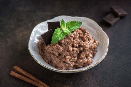 Chocolate Rice Pudding with Cinnamon. Healthy traditional homemade dessert or breakfast - Rice Pudding with dark chocolate or cacao, copy space.の写真素材