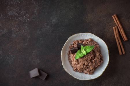 Chocolate Rice Pudding with Cinnamon. Healthy traditional homemade dessert or breakfast - Rice Pudding with dark chocolate or cacao, copy space.の写真素材
