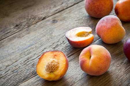 Fresh Organic Peaches on rustic wooden background with copy space. Sweet summer peaches.の写真素材