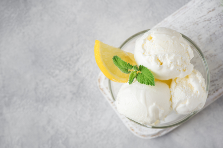 Lemon Ice Cream in bowl. Homemade citrus lemon ice cream with mint close up.の写真素材