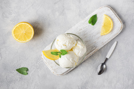 Lemon Ice Cream in bowl. Homemade citrus lemon ice cream with mint close up.の写真素材