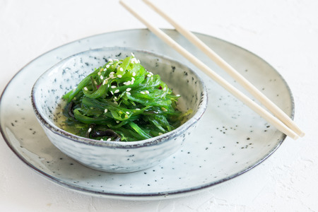 Chuka Seaweed Salad in ceramic bowl on white background, copy space. Japanese Cuisine - Chuka Saladの写真素材