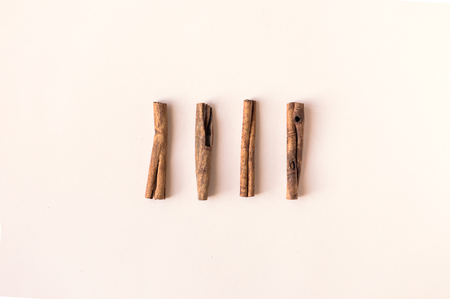 Cinnamon sticks on pink pastel background, top view.の写真素材