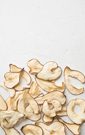 Pear fruit dehydrated chips on white background, copy space, healthy vegan snack.の写真素材