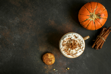 Pumpkin Spice Latte. Cup of Latte with Seasonal Autumn Spices and Cookies, top view, copy space. Traditional Coffee Drink for Autumn Holidays.の写真素材