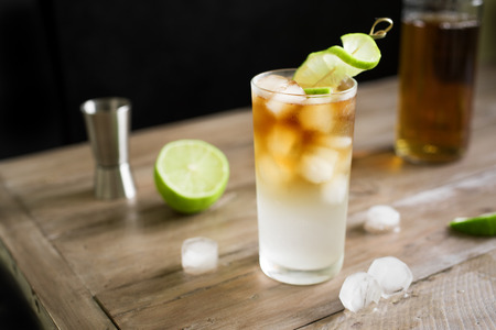 Dark and Stormy Rum Cocktail with Ginger Beer and Lime garnish. Glass of Dark and Stormy Cocktail...