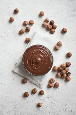 Chocolate Hazelnut Spread on white background, top view, copy space. Homemade chocolate spread with hazelnuts.の写真素材