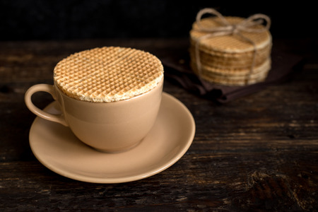 Dutch waffles, stroopwafel with caramel. Stack of traditional homemade dutch waffles on dark rustic table.の写真素材