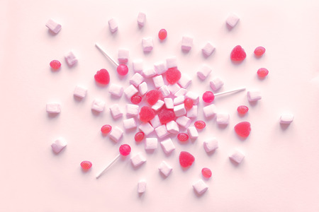 Pink candies and marshmallows pattern, background. Various pink sweets for Valentine Day as...