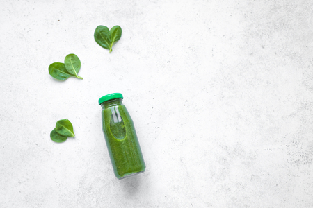 Green Smoothie Bottle  with heart shaped spinach on white background, top view. Detox, clean eating, diet and healthy eating concept, copy space.の写真素材