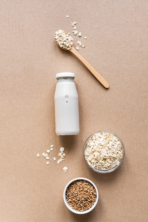 Oat milk alternative on beige background, copy space, top view. Healthy vegan substitute dairy free drink - bottle of oat milk.の写真素材