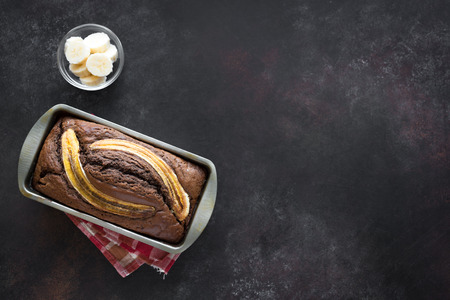 Homemade Banana Bread on rustic background, copy space. Healthy banana bread or cake for breakfast, top view.の写真素材