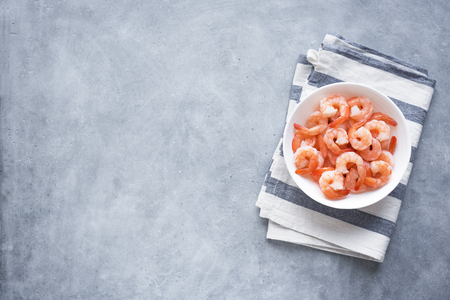 Shrimps, Prawns in bowl, top view, copy space. Fresh seafood ingredient - shrimp tails ready for cooking. Boiled prawns.の写真素材