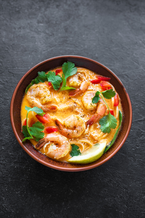 Laksa Shrimp Soup. Prawn noodle laksa soup on black background, top view, copy space. Asian Malaysian food.の写真素材