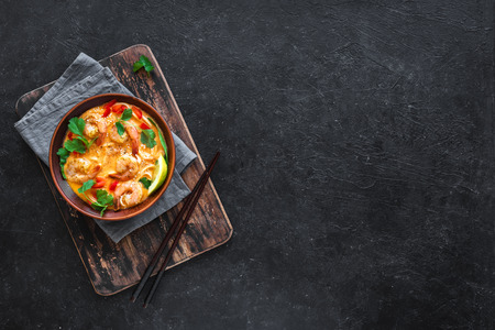 Laksa Shrimp Soup. Prawn noodle laksa soup on black background, top view, copy space. Asian Malaysian food.の写真素材