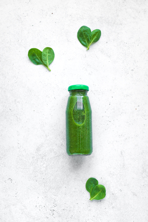 Green Smoothie Bottle on white background, top view. Detox, clean eating, diet and healthy eating concept, copy space.の写真素材