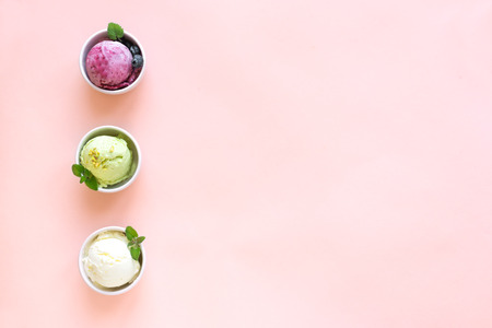 Ice Cream Assortment. Various fruit and berries ice creams on pink background, copy space. Frozen yogurt or ice cream - healthy summer dessert.の写真素材