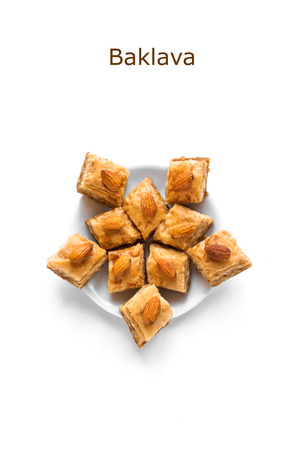 Arabic Baklava. Turkish Ramadan Dessert Baklava with almond nuts and honey isolated on white.の写真素材