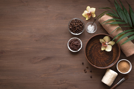 Natural Spa with coffee, sea salt and sugar, copy space, flat lay. Organic spa cosmetic products and natural skincare concept on dark wooden background.の写真素材