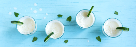 Ayran, homemade yogurt drink (kefir, lassi) with cucumbers - healthy summer refreshing cold drink, banner.の写真素材